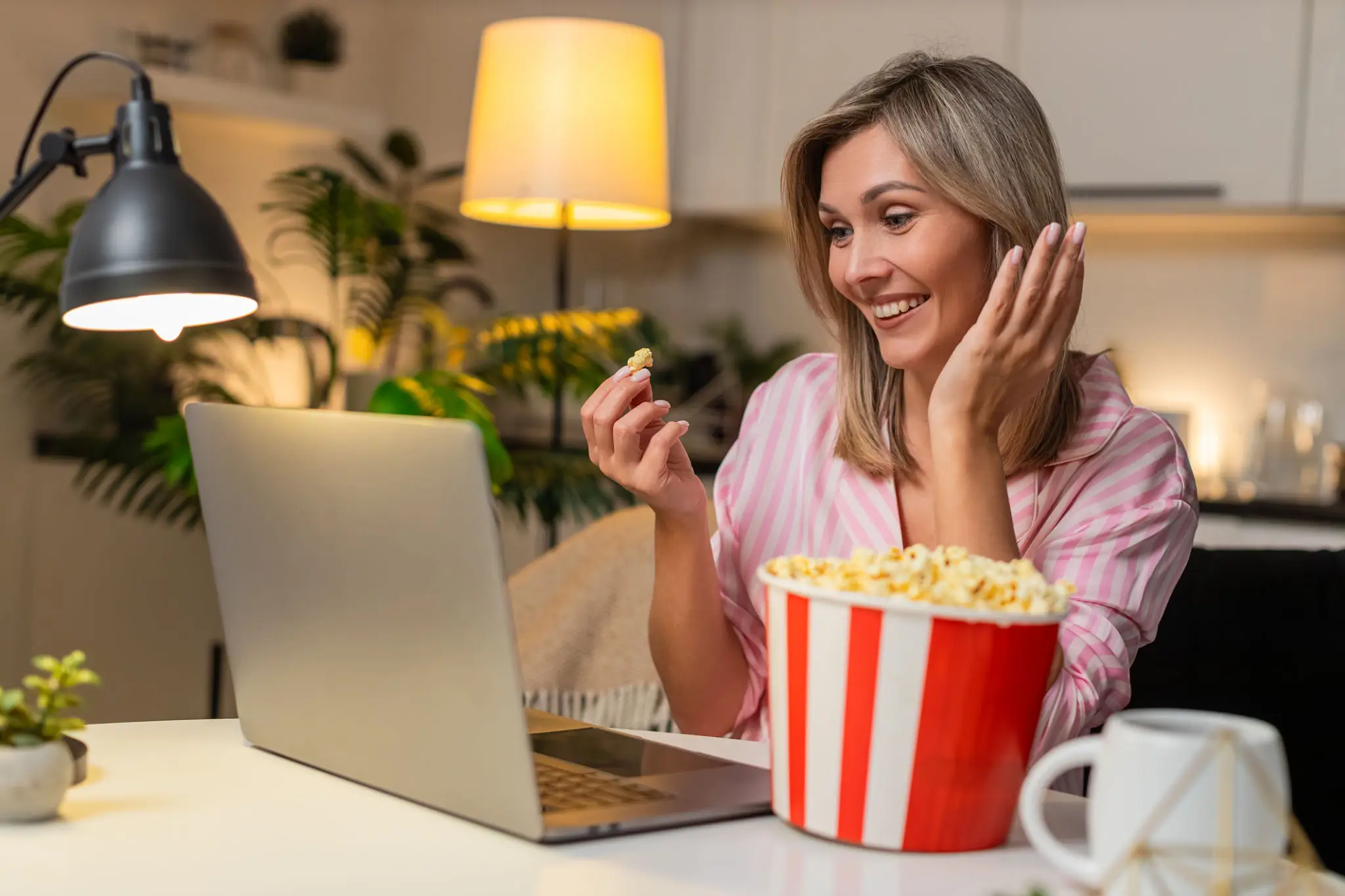 Smiling woman having movie night at home
